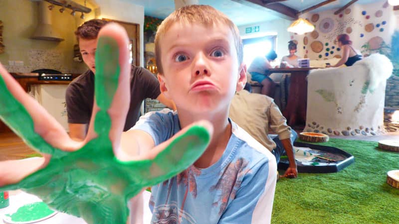 Young boy with green paint on his hands