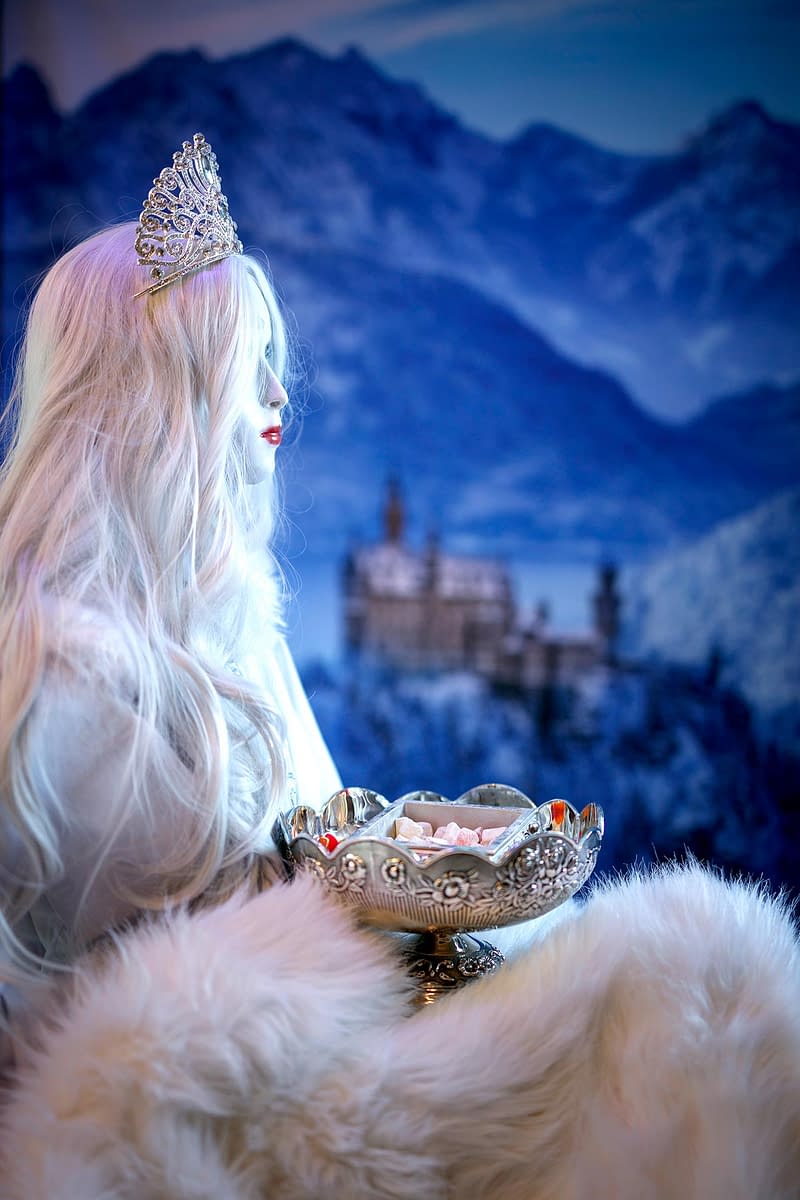The White queen holding a silver bowl of Turkish delight