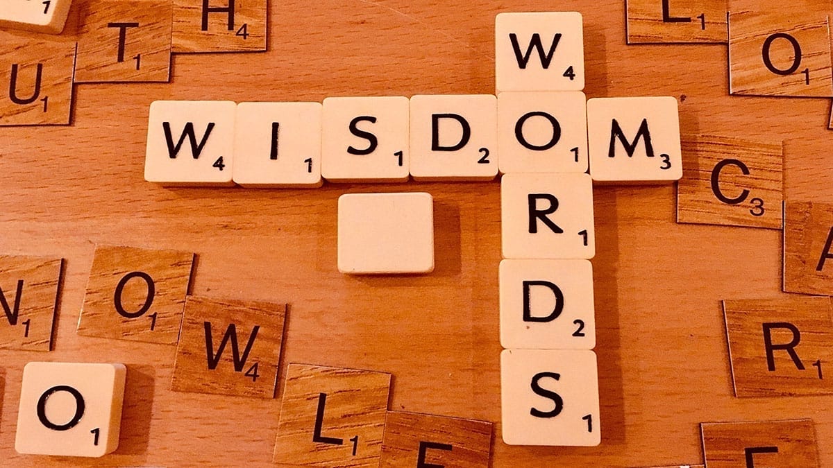 Scrabble letters spelling 'Wisdom Words'